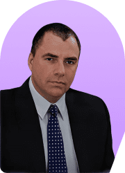 Headshot of a man in a suit and tie against a purple background.