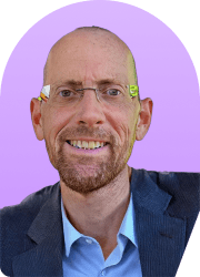Headshot of a smiling man wearing glasses against a purple background.