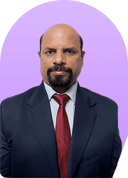 Headshot of a man in a suit and red tie against a purple background.