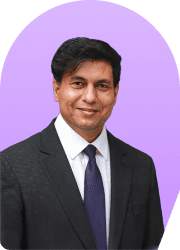 Headshot of a man in a suit against a purple background.