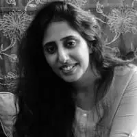 Black and white headshot of a woman with long hair.