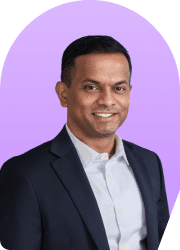 Headshot of a smiling man in a suit against a purple background.